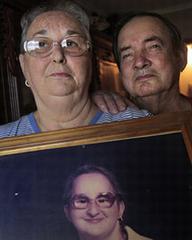 Constance and Norman Fusilier hold the senior portrait of their daughter, Cindy Harrison