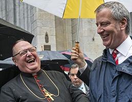 Archbishop of New York Cardinal Timothy Dolan, left, shares a light moment with New York Mayor Bill de Blasio during the annual Columbus Day Parade in New York 